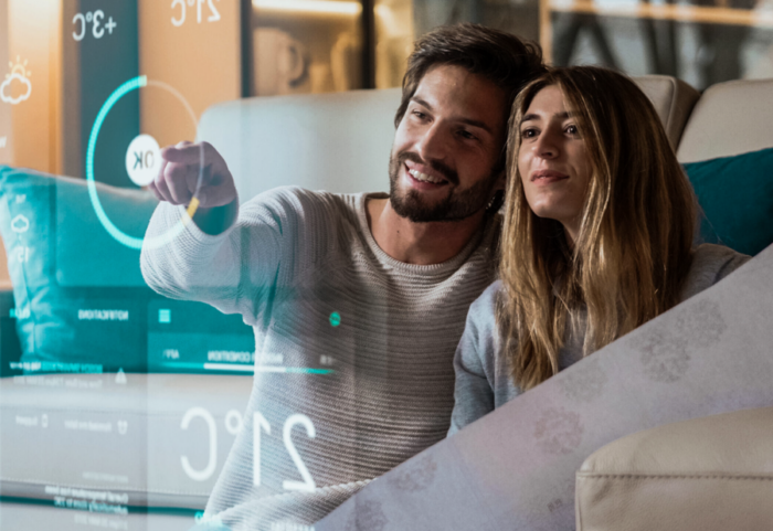 Couple using futuristic smart home interface on a transparent screen.