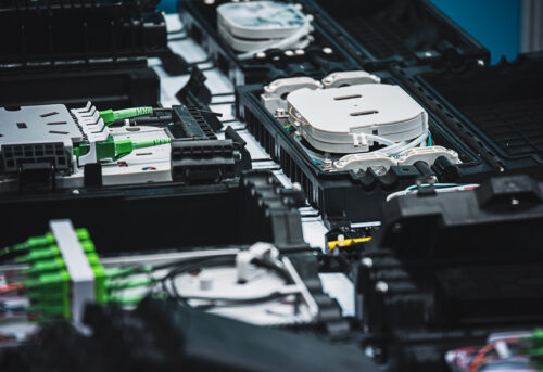Close-up of intricate electronic components, featuring connectors, wires, and enclosures.